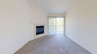 Located at 241 W Buchanan Rd in Pittsburg, CA, this 2-bedroom, 2-bathroom residence offers a practical and comfortable single-floor layout. The living room is a standout space, featuring vaulted ceilings, plush carpet, a tile-surround fireplace, and a sliding glass door that opens to a private patio, allowing for natural light and outdoor views. A ceiling fan adds comfort to the adjoining area.

The kitchen is open to the living space via a breakfast bar counter, offering warm honey-toned cabinetry, white appliances including a range, microwave, refrigerator, and dishwasher, and tile flooring for easy maintenance.

The primary bedroom is generously sized and features mirrored sliding closet doors and soft carpet flooring. The second bedroom also includes a full-width sliding closet and vertical blinds for light control. Both rooms maintain a clean, neutral palette.

The two bathrooms are finished with matching warm cabinetry, tile flooring, and white fixtures. One includes a full tub-shower combo with a vanity mirror and lighted fixture above. The second bath features a window for natural ventilation. A connecting hallway ties the layout together efficiently, making this a well-organized and functional home.