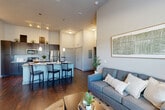 Located at 101 Church Ave in College Station, TX, this four-bedroom, four-bathroom residence offers a well-designed single-floor layout with a thoughtful blend of open communal spaces and private individual rooms. The open-concept living, dining, and kitchen area serves as the heart of the home, featuring soaring ceilings that amplify the sense of space. Rich dark hardwood-style flooring runs throughout the main areas, complemented by neutral-toned walls that create a clean, modern aesthetic. Large windows flood the living room with natural light and offer pleasant outdoor views, while a ceiling fan adds comfort overhead. The kitchen is well-appointed with dark espresso cabinetry reaching to the ceiling, granite-style countertops, stainless steel appliances, and a breakfast bar with pendant lighting — ideal for both cooking and casual dining. Each of the four bedrooms offers a private, carpeted retreat with its own dedicated closet and en-suite bathroom. The bathrooms are consistently finished with dark vanity cabinetry, granite countertops, and tub-shower combinations. Additional conveniences include a dedicated laundry room and utility room. The overall ambiance is modern and functional, making this residence well-suited for shared or family living in the heart of College Station.