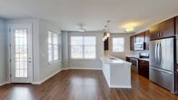 This contemporary townhouse in Oak Creek, Wisconsin, offers 1,150 square feet of thoughtfully designed living space across two floors. The main level boasts an open-concept layout, seamlessly blending the living room and kitchen. The gourmet kitchen is a highlight, featuring rich wood cabinetry, sleek stainless steel appliances, and a convenient island with a white quartz countertop. Large windows throughout flood the space with natural light, while gleaming hardwood floors add warmth and elegance.

The upper level houses two bedrooms, including a spacious 210 square foot primary suite. Both bathrooms showcase modern fixtures, with one featuring a luxurious soaking tub. The property includes two closets for ample storage. White walls and neutral carpeting in the bedrooms create a blank canvas for personalization.

Additional amenities include a staircase connecting both floors and in-unit laundry facilities. The property's location at 7781 S Drexel Ridge Way offers the perfect balance of suburban tranquility and urban convenience. With its blend of style, comfort, and functionality, this townhouse presents an ideal living solution for those seeking a contemporary home in a desirable Wisconsin neighborhood.