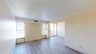 Located at 201 N Pine St in Florence, Alabama, this one-bedroom, one-bathroom unit offers a practical and comfortable layout across a single floor. The living area features warm, neutral-toned walls and light-colored carpeting, with two windows that allow generous natural light to fill the space and provide views of the surrounding area.

The kitchen is efficiently designed with light oak cabinetry offering abundant storage, a double-basin sink, light-toned countertops, and white appliances including a coil-top electric range and a full-size refrigerator. The flooring in the kitchen is durable wood-look vinyl, creating a clean and easy-to-maintain surface.

The bedroom is a comfortable size, featuring soft carpeting, neutral walls, and dual windows that brighten the room. It includes a large built-in closet with bi-fold doors for convenient storage, as well as access to an additional shelved storage area or walk-in closet space.

The bathroom is thoughtfully finished with mosaic tile flooring, a tiled tub-shower surround in a neutral gray palette, a pedestal-style sink, and built-in open shelving near the entry for linens or personal items. A textured ceiling is consistent throughout the unit, adding a classic residential character to the overall aesthetic.