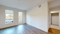 This well-appointed one-bedroom, one-bathroom residence in Rancho Cordova, California offers a clean, modern aesthetic throughout its efficiently designed single-floor layout. The living area features light-toned luxury vinyl plank flooring, crisp white walls, and large windows and a glass door that open to a private patio, flooding the space with natural light and providing pleasant outdoor views of surrounding greenery. The kitchen is a standout feature, showcasing sleek dark upper cabinetry paired with warm wood-toned lower cabinets, a striking marble-style quartz waterfall island, white quartz countertops, a marble-look tile backsplash, and a full suite of stainless steel appliances including a gas range, built-in microwave, French door refrigerator, and dishwasher. The bedroom is a comfortable retreat with soft carpeting, a bright window overlooking greenery, and access to two closets. The bathroom is finished in a clean, neutral palette with tile flooring, a tub/shower combination with subway tile surround, and built-in open shelving for added storage. Additional highlights include a dedicated laundry area and an attached private garage with an automatic opener, offering both convenience and ample storage potential.