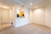 Located in Marietta, GA, this single-floor home offers a thoughtfully designed layout that balances comfort and functionality. The open living area is generously proportioned, featuring plush carpeting, a ceiling fan with light fixture, and views through to the kitchen and entryway, creating a welcoming and airy atmosphere.

The kitchen is equipped with honey-toned wood cabinetry, gray speckled countertops, a tile backsplash, and black appliances including an electric range, over-the-range microwave, and dishwasher. Durable wood-look vinyl flooring ties the space together with a clean, modern touch.

Multiple bedrooms are finished with neutral carpet, white walls, and ceiling fans, with windows fitted with blinds that frame lush, green outdoor views. One bedroom features a tray ceiling with recessed lighting, adding an elevated architectural detail. Another includes access to a walk-in closet.

The bathroom is well-appointed with stone-look tile flooring, a wood-toned vanity with a granite-style countertop, a tub-shower combination with classic white subway tile and a bold black accent border, and a natural light window above the shower. Brushed nickel hardware and grab bars provide practical, polished finishes throughout. The floor plan flows efficiently across a single level, making this home accessible and easy to navigate.