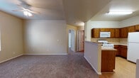 Located at 9435 Diana Dr in El Paso, TX, this single-floor home offers a practical and comfortable layout designed for everyday living. The open-concept living area features warm, neutral-toned walls, plush carpeting, and a ceiling fan, creating a relaxed and inviting atmosphere. A peninsula counter connects the living space to the kitchen, providing a natural transition between the two areas.

The kitchen is well-appointed with rich, dark wood cabinetry offering generous storage, light-toned countertops, and wood-look flooring. It comes equipped with a gas range, over-the-range microwave, and a full-size refrigerator, making it fully functional for daily use.

The bedrooms are carpeted and feature neutral walls, ceiling fans, and windows with blinds that allow for natural light while maintaining privacy. Each room offers a comfortable and versatile space suitable for various uses.

The bathroom includes a wood-toned vanity with a single sink, a large mirror with overhead lighting, a combination tub and shower, and wood-look flooring, providing a clean and functional design.

Throughout the home, consistent neutral color tones, arched interior doorways, and a mix of carpet and wood-look flooring contribute to a cohesive and understated aesthetic. The layout flows naturally, making efficient use of the available space.