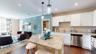 Located at 5252 Riggins Run in Dublin, Ohio, this thoughtfully designed 2-bedroom, 2-bathroom residence offers a comfortable and functional single-floor layout. The open-concept kitchen is a standout feature, showcasing white shaker cabinetry, granite-style countertops, stainless steel appliances, and a central island with seating for multiple guests, illuminated by stylish pendant lighting. The kitchen flows seamlessly into the living area, which is finished with warm neutral tones, crown molding, plush carpeting, and natural light from large windows.

Both bedrooms are carpeted and well-sized, with the primary bedroom offering generous proportions and a walk-in closet equipped with wire shelving. The second bedroom features a teal accent wall and bright windows. Each bathroom is finished with granite-style vanity countertops, white cabinetry, wood-look flooring, and a full tub-shower combination. Both closets throughout the home include built-in wire shelving systems for organized storage. The warm, neutral color palette used throughout creates a cohesive and inviting ambiance, making this Dublin residence a practical and comfortable place to call home.