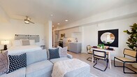 Located in the heart of downtown Sacramento at 351 6th St, Unit 508, this thoughtfully designed one-bedroom, one-bathroom residence offers a smart and efficient single-floor layout. The open-concept living, dining, and kitchen area serves as the heart of the unit, where light wood-look flooring and crisp white walls create a clean, modern aesthetic throughout.

The kitchen is well-appointed with sleek gray cabinetry, white upper cabinets, a subway tile backsplash, stainless steel appliances including a refrigerator, range, microwave, and dishwasher, and a white quartz countertop with a matte black faucet. A dedicated dining area sits adjacent to the kitchen, making entertaining easy within the open layout.

The living area benefits from large windows that bring in natural light and connects seamlessly to the rest of the unit. A barn-style sliding door adds a contemporary design touch along the hallway, which also houses in-unit laundry.

The bedroom is a cozy, well-proportioned retreat with a ceiling fan and continued wood-look flooring. The bathroom features a glass-enclosed shower, light wood flooring, and clean white walls, maintaining the unit's consistent modern palette. Recessed lighting throughout keeps the space bright and polished.