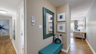 Located at Harbor Landing in Roswell, GA, this well-appointed 2-bedroom, 1-bathroom single-story home offers a cohesive and stylish living experience throughout its thoughtfully designed floor plan. Warm hardwood flooring flows seamlessly across the entire home, anchoring each room with a sense of continuity.

The welcoming entryway hallway features a decorative teal-framed mirror, framed agate wall art, and a built-in security system panel. The spacious living room boasts a classic wood-burning fireplace, soft sage-toned walls, and ample room for comfortable seating arrangements. Adjacent dining areas offer both a formal dining space with large windows that invite natural light and a casual breakfast nook with garden-inspired wall décor.

The kitchen is outfitted with crisp white cabinetry, granite countertops, a white subway tile backsplash, and stainless steel appliances, combining functionality with clean, modern aesthetics.

The primary bedroom is a standout, featuring a striking large-scale floral wall mural, ceiling fan, and generous natural light from multiple windows. The second bedroom is equally comfortable, with access to a walk-in closet. The shared bathroom includes a granite-topped vanity, white cabinetry, and a tub-shower combination. Dedicated closets provide practical storage throughout this refined and move-in-ready home.