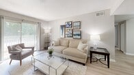 Located in Atlanta, GA, this two-bedroom, two-bathroom residence offers a thoughtfully designed single-floor layout that maximizes every square foot. Light wood-style flooring flows through the main living areas, creating a clean, cohesive aesthetic complemented by neutral wall tones throughout.

The living room is bright and welcoming, with a sliding glass door that invites natural light and provides access to an outdoor balcony. Adjacent to it, the dedicated dining area features its own overhead lighting fixture, offering a defined space for meals and entertaining.

The galley-style kitchen is well-equipped with white cabinetry, granite-look countertops, stainless steel appliances including a refrigerator and dishwasher, and a built-in range — all framing a clear sightline into the dining area beyond.

Both bedrooms are carpeted for comfort. The primary bedroom is generously sized with a closet and ample wall space, while the second bedroom benefits from a large window that brings in natural light. Each bathroom includes a tub/shower combination, white tile surround, and granite-look vanity countertops, maintaining the home's consistent, modern finishes.

Hallways connect the rooms efficiently, rounding out a practical and comfortable floor plan suited for everyday living.