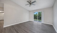 This single-story residence in Port Saint Lucie offers a generous 1030 square feet of living space, efficiently arranged to accommodate five bedrooms and two bathrooms. The home's layout maximizes functionality, with a combined kitchen and living area serving as the central hub. The kitchen boasts light wood cabinetry, contrasting black appliances, and a practical L-shaped counter with additional bar seating. Wood-look flooring in the main living areas adds a touch of warmth and durability.

The bedrooms feature neutral-toned carpeting and ample closet space with sliding doors, providing a cozy and comfortable atmosphere. The bathrooms are outfitted with modern fixtures, including a vanity with storage and a combination bathtub-shower. Large windows in the bedrooms allow for natural light, while window treatments offer privacy control.

Throughout the home, neutral wall colors create a blank canvas for personal decorating styles. The property's layout, as seen in the 3D floor plan, reveals a well-thought-out design that balances private and communal spaces. With its spacious primary bedroom of 170 square feet and multiple secondary bedrooms, this home is well-suited for families or those needing extra space for work or hobbies.