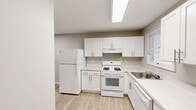 Located at 1700 RT 37 W in Toms River, NJ, this single-floor, 2-bedroom, 2-bathroom home offers a well-designed layout with a neutral, modern aesthetic throughout. Light wood-style flooring runs continuously through the living, dining, and kitchen areas, creating a cohesive and airy feel. The open-concept living and dining space is generously proportioned, featuring recessed lighting and large windows that allow natural light to fill the room. The kitchen is equipped with crisp white shaker-style cabinetry, light stone countertops, a gas range, dishwasher, full-size refrigerator, stainless steel sink, and a skylight overhead that enhances brightness. Both bedrooms are finished in a soft blue-gray tone with light hardwood-style flooring and bright windows. The spacious primary bedroom features direct access to a bathroom and dedicated closet space. With five closets throughout, storage is plentiful. Both bathrooms are finished with tile flooring, white vanities, mirrored medicine cabinets, and accessibility-friendly grab bars. The overall ambiance is clean, functional, and move-in ready, making it well-suited for comfortable single-floor living.