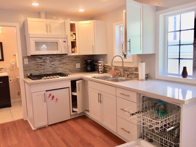 Kitchen with refrigerator, stove, microwave, and dishwasher - 1348 S Curson Ave