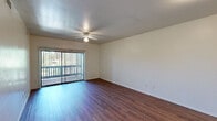 Located at 997 East Pine Knoll Drive in Flagstaff, Arizona, this one-bedroom, two-bathroom unit offers a well-organized single-floor layout designed for comfortable everyday living. Rich wood-look flooring runs consistently throughout the space, lending a warm, cohesive aesthetic to every room.

The living room is a highlight of the unit, featuring a ceiling fan with light fixture and a sliding glass door dressed with vertical blinds that opens to a private balcony overlooking mature trees and the surrounding neighborhood. The space receives generous natural light, creating an inviting and airy atmosphere.

The galley-style kitchen is efficiently designed with warm wood cabinetry, light laminate countertops, a double stainless steel sink, and white appliances including a refrigerator, electric range, microwave, and dishwasher. A window above the counter brings in additional natural light.

The spacious primary bedroom includes a ceiling fan, multiple windows with outdoor views, and ample wall space. A secondary room with a window offers flexibility as an office or additional living space.

Two full bathrooms serve the unit — one featuring a tub/shower combination with tile surround, and the other offering a wide vanity with wood cabinetry, a large mirror, and bright overhead lighting. Hallways connect the rooms efficiently throughout the layout.