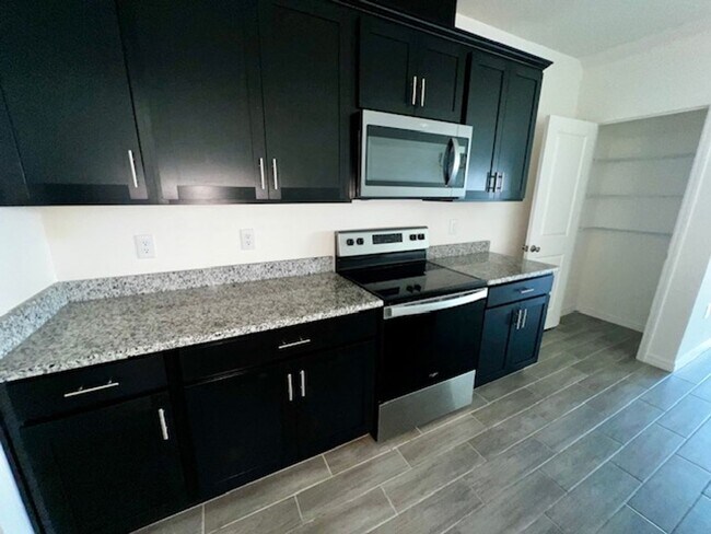 Building Photo - MOVE IN NOW!! NEW 3 x2.5 TOWNHOME WITH 1 C...