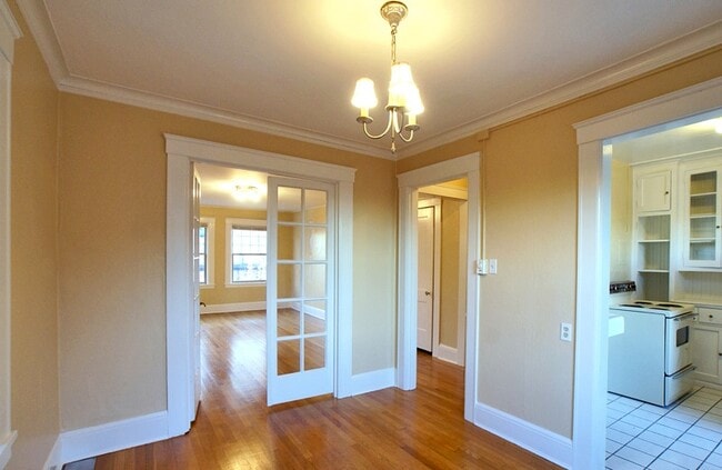 Dining room with french doors, crown molding and hardwoods, overlooking greenery - 1621 17th Ave