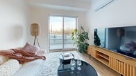 Located at 62-64 Boul de Lucerne in Gatineau, Quebec, this well-designed 3-bedroom, 1-bathroom unit offers a thoughtful layout across a single floor. The open-concept kitchen and living area forms the heart of the home, featuring white cabinetry, stainless steel appliances, a generous island with a light quartz countertop, and warm light wood flooring that extends throughout. Pendant lighting and recessed fixtures add a clean, modern touch to the kitchen. The living room is bright and inviting, with large sliding glass doors opening onto a private balcony that brings in abundant natural light and outdoor views. The primary bedroom is a comfortable retreat, benefiting from wide windows that frame the surrounding scenery, complemented by light wood flooring. The two additional bedrooms are well-proportioned and versatile. The bathroom is finished in a clean, contemporary style with large-format tile flooring, a white vanity with ample storage, a full bathtub with shower, and a well-lit mirror. A long hallway connects the rooms efficiently, adorned with artwork that adds character. The overall ambiance is bright, modern, and cohesive throughout.