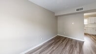Located at 2609 Granite Hill Cir in Richmond, VA, this two-floor home presents a clean, updated interior designed with a cohesive neutral aesthetic. The main level opens into a spacious living area featuring wood-look luxury vinyl plank flooring and a front-facing window that invites natural light. The flooring continues seamlessly into the kitchen, which is well-appointed with white shaker-style cabinetry, light quartz-style countertops, a subway tile backsplash, stainless steel sink, and stainless steel appliances including a refrigerator and electric range. A pendant light fixture overhead adds a refined touch to the kitchen space. The layout also reveals a dedicated dining area adjacent to the kitchen. Upper-level rooms feature soft, neutral carpet and generous wall space, offering versatile use as bedrooms or living areas. A closet with hallway access and a landing with a stair rail detail are also present on the upper level. The bathroom is outfitted with a full tub-shower combination, a white vanity with a clean countertop, chrome fixtures, and a framed mirror. Throughout the home, white trim, consistent neutral wall tones, and updated finishes create a bright, move-in-ready atmosphere.