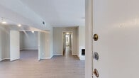 Located in Houston's desirable 77056 corridor, this well-appointed 3-bedroom, 3-bathroom residence offers a thoughtfully designed single-floor layout with a generous, flowing floor plan. Light wood-style flooring runs throughout, creating a bright and cohesive aesthetic. The open living room is anchored by a white brick wood-burning fireplace and a ceiling fan, with sliding glass doors that lead directly to a private balcony overlooking lush, tree-lined surroundings with a skylight overhead. The kitchen features white cabinetry, granite-look countertops, stainless steel appliances, and a pass-through opening to the living area, allowing natural light to flow freely. Each bedroom is well-proportioned, with the primary suite offering its own sliding glass door access to the balcony, a ceiling fan, and a spacious walk-in closet outfitted with built-in shelving and hanging rods. The primary bathroom includes an extended vanity with granite-look counters, white cabinetry, and a large mirror with overhead lighting. Additional bathrooms provide clean, tiled tub-shower combinations. The entrance and hallway connect all spaces efficiently, completing a comfortable and functional residence.