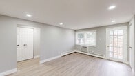 Located at 1 Harned Ave in Somerdale, NJ, this thoughtfully updated one-bedroom, one-bathroom unit offers a clean, modern aesthetic throughout its efficiently designed single-floor layout. Light-toned luxury vinyl plank flooring runs seamlessly through the living areas, kitchen, hallway, and bedroom, creating a cohesive and easy-to-maintain interior.

The kitchen is a standout feature, outfitted with gray shaker-style cabinetry, white quartz countertops, a subway tile backsplash, and a full suite of stainless steel appliances including a gas range, over-the-range microwave, and refrigerator. A window brings in natural light and overlooks greenery outside. Conveniently tucked within the hallway area is a stacked washer and dryer unit, adding in-unit laundry to the home's practical appeal.

The bedroom offers a comfortable and quiet retreat, featuring a large window with views of mature trees, a baseboard heating unit, and two closets with panel doors. The bathroom is finished with large-format tile flooring and a tub/shower combination clad in floor-to-ceiling gray tile, complemented by brushed nickel fixtures. Neutral gray walls, white trim, and flush-mount lighting tie the entire space together in a fresh, contemporary style.