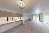 Located at 1504 Yorkshire Dr in Howell, Michigan, this single-floor, one-bedroom, one-bathroom residence offers a practical and well-organized layout. The open-concept living and dining area forms the heart of the home, featuring wall-to-wall carpeting, a textured ceiling, and a sliding glass door that fills the space with natural light and provides direct access to a private balcony with outdoor views. A pass-through counter connects the living area to the galley-style kitchen, which is equipped with white cabinetry featuring wood-trimmed accents, a double sink, a dishwasher, an electric range, and a refrigerator, all set atop easy-care tile flooring. A hallway connects the main living space to the private bedroom, which is generously proportioned and features carpet flooring, a window overlooking greenery, and two closets offering abundant storage. The full bathroom is conveniently positioned near the bedroom. Throughout the residence, four closets in total provide exceptional storage capacity. The neutral color palette, consistent carpeting, and textured ceilings create a cohesive, functional ambiance well-suited for comfortable everyday living.