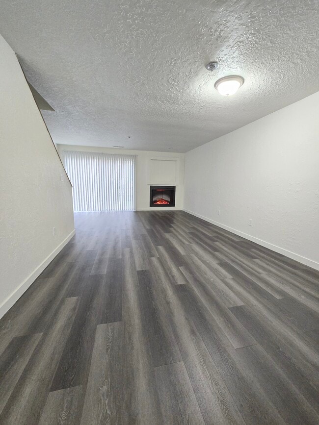 LIVING AREA WITH ELECTRIC FIREPLACE - St James Condominiums