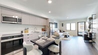 Located at 127 W Pomona Ave in Monrovia, California, this thoughtfully designed one-bedroom, one-bathroom unit offers a modern living experience with clean lines and contemporary finishes throughout. Light wood-tone flooring flows seamlessly across the open-concept layout, connecting the living room, dining area, and kitchen into one cohesive space. The living room is bright and welcoming, featuring large windows and a glass door that opens to an outdoor area, filling the room with natural light and providing direct access to the exterior. The kitchen is outfitted with sleek, flat-front cabinetry in a warm taupe finish, stainless steel appliances including a range, microwave, and dishwasher, and clean countertops that provide ample prep space. A dining area sits adjacent, comfortably accommodating a four-seat table. The bedroom is a calm, carpeted retreat with a large window overlooking greenery and neighboring architecture, paired with a built-in sliding-door closet. The hallway connects the bedroom to the well-appointed bathroom, which features a minimalist vanity with drawer storage, a large mirror, light wood flooring, and a frosted glass door for added privacy. The overall ambiance is clean, modern, and move-in ready.