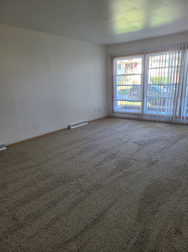 Spacious living room with new windows - 4329 N 91st St