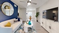 Located in Sandy Springs, GA, this well-appointed 2-bedroom, 2-bathroom residence offers a thoughtfully designed single-level layout that balances comfort and functionality. The open living area welcomes you with light wood-look flooring, a ceiling fan, and a bold blue accent wall that adds a distinct visual anchor to the space. Natural light filters in through plantation-shuttered windows, and the room flows seamlessly into a defined dining area, creating an inviting, open feel.

The kitchen features granite countertops, white cabinetry, and stainless steel appliances, including a dishwasher and refrigerator, offering both style and practicality.

The spacious primary bedroom includes plush carpet, a ceiling fan, sliding glass door access, and an ensuite bathroom with a wide granite-topped vanity, white cabinetry, and wood-look flooring. The second bedroom is equally comfortable, highlighted by a vibrant orange accent wall, carpet flooring, a ceiling fan, and a sliding glass door. The second bathroom mirrors the refined finishes of the first, featuring a granite vanity and a tub-shower combination with a decorative curtain.

Three closets and three hallways throughout the unit provide ample storage and ease of circulation, completing this well-organized and stylishly finished residence.