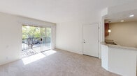 Located at 200 S Citron St in Anaheim, California, this single-floor unit offers a well-organized and functional layout throughout. The living area is bright and welcoming, featuring plush carpeting and a large sliding glass door that opens to a private balcony overlooking mature trees and the surrounding streetscape, allowing natural light to fill the space. Adjacent to the living area, the kitchen is equipped with warm oak cabinetry, a double-basin stainless steel sink, granite-look laminate countertops, a stainless steel dishwasher, and a pendant light fixture above the counter, complemented by a window with blinds.

The bedrooms are carpeted and bright, with one room featuring a ceiling fan with light, a thermostat, and direct access to a hallway with built-in cabinetry. A second bedroom offers a window framing pleasant outdoor greenery. Storage is a notable feature, with a generously sized walk-in closet outfitted with wrap-around shelving and hanging rods. The bathroom includes warm-toned tile flooring, a wood-trimmed vanity with a granite-look countertop, a framed mirror, and a separate room housing the bathtub and shower combination. The overall aesthetic is clean and neutral, offering a versatile canvas throughout.