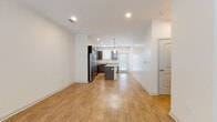 Located at 2024 Barr Rd in Kannapolis, NC, this two-floor residence offers a well-designed layout with modern finishes throughout. The main level opens into a spacious living area with light hardwood-style flooring, recessed lighting, and a ceiling fan, creating a bright and airy atmosphere. Natural light filters in through multiple windows, enhancing the open feel of the space.

The kitchen is a standout feature, showcasing rich dark cabinetry, granite countertops, a central island with additional counter space, and a full suite of stainless steel appliances including a refrigerator, range, microwave, and dishwasher. Pendant lighting above the island adds a polished finishing touch, while a door provides convenient access to the exterior.

The bedrooms are carpeted for comfort and include ceiling fans and windows that bring in natural light. Each room offers generous proportions with walk-in or standard closet access. The bathrooms are finished with the same dark cabinetry and granite countertops seen in the kitchen, maintaining a cohesive aesthetic. One bathroom features a glass-enclosed walk-in shower, while another includes a full tub-shower combination. A half bath with a vanity and hardwood-style flooring is also present. The overall design balances functionality with contemporary style throughout both floors.