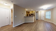 Located at 1604 E Crossings Pl in Westlake, Ohio, this single-floor residence offers a functional and well-appointed layout designed for comfortable everyday living. The open-concept living and dining area is finished with warm hardwood-style flooring and neutral-toned walls, creating a bright and inviting atmosphere. A sliding glass door with vertical blinds allows natural light to pour in while providing outdoor access.

The kitchen is efficiently designed with a peninsula breakfast bar featuring granite-style countertops, light wood cabinetry, and a full suite of stainless steel appliances, including a refrigerator, range, microwave, and dishwasher. Recessed lighting overhead keeps the space well-lit. Directly off the kitchen, a dedicated in-unit laundry room with built-in shelving adds significant convenience.

The bedrooms are carpeted for comfort, with one room featuring a sliding glass door and a window that brings in natural light and outdoor views. The bathroom is thoughtfully finished with a granite-topped vanity, light wood cabinetry, a large mirror, and a full tub-shower combination. Clean white fixtures and hardwood-style flooring complete the space. Overall, the residence presents a cohesive, move-in-ready environment with practical amenities throughout.