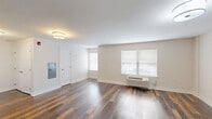 This one-bedroom, one-bathroom unit at 998 N Washington Ave in Green Brook, NJ offers a thoughtfully designed layout with modern finishes throughout. Rich hardwood-style flooring runs continuously across the living, kitchen, and bedroom spaces, lending a cohesive and polished aesthetic.

The open-concept kitchen and living area forms the heart of the unit. The kitchen is outfitted with gray shaker-style cabinetry, light marble-toned granite countertops, a subway tile backsplash, and a full suite of stainless steel appliances including a refrigerator, range, microwave, and dishwasher. The adjoining living area is generously proportioned, featuring neutral walls, a wall-mounted HVAC unit, and windows fitted with blinds that allow natural light to filter in.

The bedroom is a comfortable, well-sized space with two windows providing additional natural light and a dedicated closet for storage. The bathroom features wood-look tile flooring, a tub-shower combination with full tile surround, and a gray vanity with a stone-top countertop, complementing the unit's consistent modern design language.

Clean white millwork, panel-style doors, and a neutral color palette throughout contribute to a bright, move-in-ready atmosphere that balances functionality with contemporary style.
