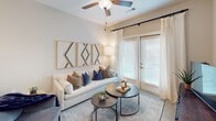 Located at 1139 Bragg Way in Myrtle Beach, SC, this single-floor residence offers a thoughtfully designed layout with a clean, contemporary aesthetic throughout. The open-concept kitchen is a standout feature, showcasing white shaker cabinetry, granite countertops, a white subway tile backsplash, and a full suite of stainless steel appliances, including a French door refrigerator, range, microwave, and dishwasher. Pendant lighting and ample cabinet storage complete this functional and stylish space. The living area flows naturally from the kitchen and is bathed in natural light from large windows and a glass door, enhanced by ceiling fans and neutral-toned walls that create a warm, inviting ambiance. The bedrooms are generously sized, each featuring ceiling fans, multiple windows with blinds and curtain panels, and a serene, restful atmosphere. The bathroom is clean and well-finished, featuring granite countertops, white cabinetry, and a tiled tub-shower combination. Consistent flooring and neutral tones carry throughout the residence, contributing to a cohesive and modern feel. This Myrtle Beach home offers comfortable, well-appointed living in a bright and welcoming environment.