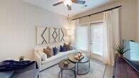 Located at 1139 Bragg Way in Myrtle Beach, SC, this single-floor residence offers a thoughtfully designed layout with a clean, contemporary aesthetic throughout. The open-concept kitchen is a standout feature, showcasing white shaker cabinetry, granite countertops, a white subway tile backsplash, and a full suite of stainless steel appliances, including a French door refrigerator, range, microwave, and dishwasher. Pendant lighting and ample cabinet storage complete this functional and stylish space. The living area flows naturally from the kitchen and is bathed in natural light from large windows and a glass door, enhanced by ceiling fans and neutral-toned walls that create a warm, inviting ambiance. The bedrooms are generously sized, each featuring ceiling fans, multiple windows with blinds and curtain panels, and a serene, restful atmosphere. The bathroom is clean and well-finished, featuring granite countertops, white cabinetry, and a tiled tub-shower combination. Consistent flooring and neutral tones carry throughout the residence, contributing to a cohesive and modern feel. This Myrtle Beach home offers comfortable, well-appointed living in a bright and welcoming environment.