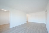 This well-appointed 2-bedroom, 1-bathroom unit at 195 Fifth Ave in Kitchener, Ontario offers a thoughtfully designed layout across a single floor. The entrance leads into a functional hallway that connects to the main living areas. The open living and dining rooms are generously sized, featuring light-toned laminate flooring, crisp white walls, and baseboard heating throughout, creating a clean and cohesive aesthetic.

The kitchen is a standout feature, finished with white shaker-style cabinetry, dark countertops, and a classic white subway tile backsplash. Stainless steel appliances — including a refrigerator, stove, and over-the-range microwave — add a modern touch, while light hardwood-style flooring enhances the bright, airy feel. Natural light flows in through a window overlooking the surrounding neighbourhood.

Both bedrooms are comfortably proportioned with the same light laminate flooring and white walls. The primary bedroom offers ample space, while the second bedroom includes a built-in closet. Windows in each room provide natural light and neighbourhood views.

The bathroom is tastefully renovated, featuring a wide vanity with a white countertop and undermount sink, large-format tile flooring, and a tub and shower surround clad in white subway tile. A private balcony completes the unit, offering views of the quiet residential street below.