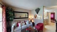 This 1-bedroom, 1-bathroom residence is thoughtfully designed to maximize comfort and functionality across a single floor. The living room serves as the heart of the home, featuring neutral-toned walls, a textured ceiling, and a large wall mirror that adds depth and amplifies the sense of space. A pass-through opening connects the living area to the kitchen, enhancing the open feel of the layout.

The galley-style kitchen is efficiently organized with light wood cabinetry lining both sides, granite-look countertops, a stainless steel sink, and a full suite of appliances including a coil-top range, refrigerator, and dishwasher. A tile floor and ample upper and lower cabinet storage round out this practical cooking space.

Adjacent to the living room, a dedicated dining area accommodates a four-seat table and is finished with a ceiling fan with lighting overhead, adding both comfort and functionality to the space.

The bedroom offers a cozy retreat with plush carpeting, a window with draping for natural light and privacy, and a generous double closet providing substantial storage. The bathroom features a vanity with granite-look countertops, a large mirror with overhead lighting, white cabinetry, and a full tub-shower combination with marble-look surround panels.