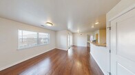Located at 2060 Country Squire Ct in West Lafayette, Indiana, this 1-bedroom, 1-bathroom unit offers a thoughtfully designed single-floor layout that maximizes every square foot of its compact footprint. The open-concept living and kitchen area serves as the heart of the unit, showcasing rich hardwood-style flooring that flows throughout the main living space. Large windows allow natural light to fill the room, creating a bright and welcoming atmosphere. The kitchen is equipped with dark espresso cabinetry, granite-style countertops, stainless steel refrigerator, electric range, and a built-in microwave. A peninsula counter provides additional workspace and casual dining potential. The bedroom features soft carpeting, a generous walk-in closet, and a secondary closet for ample storage, along with a window that brings in natural light. The full bathroom includes a tiled tub-shower combination with chrome fixtures, maintaining a clean and functional design. Additional highlights include a dedicated laundry area and multiple closets throughout the unit. The neutral color palette and clean finishes create a versatile backdrop suitable for a variety of interior styles, making this unit a practical and comfortable home in West Lafayette.