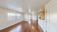 Located at 2060 Country Squire Ct in West Lafayette, Indiana, this 1-bedroom, 1-bathroom unit offers a thoughtfully designed single-floor layout that maximizes every square foot of its compact footprint. The open-concept living and kitchen area serves as the heart of the unit, showcasing rich hardwood-style flooring that flows throughout the main living space. Large windows allow natural light to fill the room, creating a bright and welcoming atmosphere. The kitchen is equipped with dark espresso cabinetry, granite-style countertops, stainless steel refrigerator, electric range, and a built-in microwave. A peninsula counter provides additional workspace and casual dining potential. The bedroom features soft carpeting, a generous walk-in closet, and a secondary closet for ample storage, along with a window that brings in natural light. The full bathroom includes a tiled tub-shower combination with chrome fixtures, maintaining a clean and functional design. Additional highlights include a dedicated laundry area and multiple closets throughout the unit. The neutral color palette and clean finishes create a versatile backdrop suitable for a variety of interior styles, making this unit a practical and comfortable home in West Lafayette.
