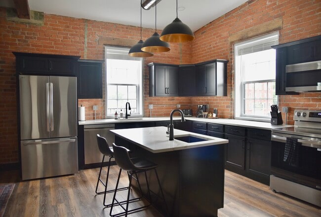 Kitchen with stainless steel appliance. - 101 W Broadway St