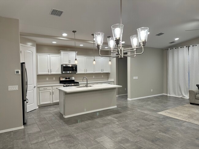 Attached covered backyard patio adjacent to kitchen & family room. - 6272 Barn Owl Ave