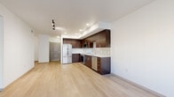 Located at 3111 S St in Sacramento's desirable 95816 zip code, this well-designed one-bedroom, one-bathroom unit offers a thoughtful layout across a single floor. The open-concept kitchen and living area serves as the heart of the space, featuring rich dark-wood cabinetry, a full suite of stainless steel appliances including a refrigerator, range, built-in microwave, and dishwasher, complemented by a classic white subway tile backsplash and light-toned countertops. Light hardwood flooring flows throughout the main living areas, creating a warm and cohesive atmosphere. Recessed lighting and track lighting illuminate the space effectively. The living area benefits from natural light through large windows, providing a bright and airy feel. The bedroom offers plush carpeting, a window with outdoor views, and a dedicated closet for storage. The bathroom is well-appointed with dark wood cabinetry, a wide vanity mirror, a soaking tub with shower, built-in shelving, and matching light hardwood-style flooring. Multiple hallway segments connect the rooms efficiently, contributing to a clean, organized flow throughout the unit. Overall, the space presents a modern aesthetic with quality finishes throughout.