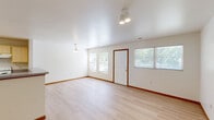Located at 701 W Grand Ave in Decatur, Illinois, this two-story home offers three bedrooms, three bathrooms, and a well-designed layout spread across two floors. The main level features an open-concept living, dining, and kitchen area finished with light hardwood-style flooring throughout. Large windows flood the space with natural light, creating a bright and airy atmosphere. A pendant light fixture accents the dining area, while track lighting provides functional illumination in the living space. The front entry features warm wood-trimmed doors that add a welcoming touch.

Upstairs, the bedrooms are carpeted for comfort and include ceiling fans and windows with outdoor views of the surrounding greenery. The spacious primary bedroom offers a generous footprint and ample room for furnishings. The bathrooms are clean and functional, featuring tub/shower combinations, vanities with gray countertops, light wood cabinetry, and large mirrors with overhead lighting.

Throughout the home, an impressive eight closets provide exceptional storage. Additional highlights include an attached garage, a patio for outdoor enjoyment, and two staircases connecting the floors. The home's clean, neutral palette and practical layout make it a versatile and comfortable residence.