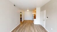 This single-story unit in Goodyear, Arizona offers a thoughtfully designed layout that maximizes functionality across one bedroom and one bathroom. The open living area is finished with warm wood-style luxury vinyl plank flooring that extends throughout, complemented by neutral-toned walls and clean white baseboards that create a bright, cohesive aesthetic.

The kitchen is a standout feature, equipped with a full suite of stainless steel appliances including a refrigerator, electric range, and over-the-range microwave. Crisp white shaker-style cabinetry provides ample storage, while a gray subway tile backsplash and neutral countertops add a contemporary touch. A peninsula counter connects the kitchen to the living area, enhancing the open feel.

The bedroom offers generous proportions, wood-style flooring, a ceiling fan with light fixture, and a window that allows natural light to fill the space. The bathroom is finished with wood-style flooring, a tub-shower combination, a vanity with a white countertop, and neutral wall tones throughout.

A dedicated laundry area houses a full-size washer and dryer, adding everyday convenience. The unit's clean, modern finishes and practical layout make it a functional and attractive living space.