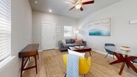 Located at 37136 Eiland Blvd in Zephyrhills, FL, this well-designed one-bedroom, two-bathroom residence offers a smart and functional single-floor layout. The open-concept living area greets you with light wood-style flooring, neutral gray walls, and a ceiling fan, creating a bright and welcoming atmosphere. Natural light filters in through multiple windows fitted with clean white blinds. The living room flows seamlessly into the kitchen and dining area, making the space feel open and connected. The kitchen is a standout feature, boasting white shaker-style cabinetry, granite countertops, a white subway tile backsplash, stainless steel appliances, and a peninsula with bar seating illuminated by pendant lighting—ideal for casual dining or entertaining. The bedroom offers plush carpeting, a sliding closet, a wall-mounted mini-split unit, and a window for natural light, providing a cozy and private retreat. Two bathrooms serve the residence, one featuring a granite-topped vanity with modern cabinetry and a tub-shower combination with light wood-style flooring. Throughout the home, clean finishes, recessed lighting, and a cohesive neutral palette contribute to a modern yet comfortable ambiance suited for everyday living.