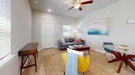 This 570 square foot apartment in Zephyrhills, FL, offers a thoughtfully designed living space that maximizes efficiency and style. The single-floor layout features an open-concept living area that seamlessly integrates the kitchen, dining, and living room. The kitchen boasts modern white cabinetry, granite countertops, and stainless steel appliances, including a sleek range and over-the-range microwave. A breakfast bar with stylish seating provides additional dining space.

The living room is bathed in natural light from large windows and showcases a contemporary aesthetic with a mix of modern and mid-century inspired furniture. A ceiling fan adds both style and function. The bedroom, measuring 160 square feet, features plush carpeting, ample closet space, and is equipped with a wall-mounted air conditioning unit for personalized comfort.

Two well-appointed bathrooms offer convenience and privacy. One bathroom features a vanity with a granite countertop and a shower/tub combination. Throughout the apartment, neutral tones create a calm atmosphere, while pops of color in the furnishings add vibrancy. Light wood-look flooring in the main living areas contributes to the bright, airy feel of the space. Despite its compact size, this apartment doesn't compromise on style or functionality, offering a cozy yet modern living environment.