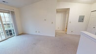 This one-bedroom, one-bathroom unit at Winfield Farms Apartments in Lafayette, Indiana, offers a practical and efficiently designed layout across a single floor. The living room is a notable highlight, featuring vaulted ceilings that lend a sense of openness beyond the unit's modest footprint. Neutral-toned carpet runs throughout the living and bedroom areas, while sliding glass doors provide access to a private balcony, allowing natural light to fill the space.

The kitchen is positioned adjacent to the living area and separated by a half-wall breakfast bar, creating an open yet defined boundary between spaces. It features warm oak cabinetry, laminate countertops, hardwood-style flooring, and white appliances including a refrigerator, electric range, and built-in microwave.

The bedroom is a cozy, carpeted room with a window fitted with blinds that admit natural light. A six-panel door leads to a closet, and the textured ceiling adds subtle architectural detail.

The bathroom includes a full soaking tub with a wall-mounted grab bar, a toilet, and a warm oak vanity topped with a laminate countertop and single sink. A large mirror with overhead lighting completes the space. Overall, the unit maintains a clean, neutral palette throughout.
