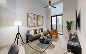 Located at 18412 Homestead Ave in Miami, FL, this thoughtfully designed residence offers three bedrooms and two bathrooms across a single floor. The open-concept layout connects the kitchen and dining area seamlessly, with the kitchen showcasing two-tone cabinetry with matte black hardware, subway tile backsplash, stainless steel appliances, and a sleek quartz countertop. A glass dining table anchors the combined dining space, adding a contemporary touch. The living room features soaring ceilings, light wood-style flooring, a ceiling fan, and sliding glass doors that open to a private patio with views of the building's courtyard and lush landscaping. The primary bedroom offers impressive ceiling height, a walk-in closet, and a serene, light-filled atmosphere. Additional bedrooms are bright and well-proportioned, with large windows fitted with roller shades. Both bathrooms are finished in neutral tones, one featuring a tiled tub-shower combination and the other a frameless glass walk-in shower, each with wood-toned vanities and white quartz countertops. Throughout the unit, light wood-style flooring, crisp white walls, and consistent modern fixtures create a cohesive and inviting aesthetic ideal for contemporary living in South Miami.