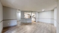 Located at 4106 Vista Verde Dr in New Port Richey, FL, this 2-bedroom, 2-bathroom single-story home offers a practical and well-appointed layout throughout. Light wood-style flooring flows consistently across the living areas, complemented by neutral gray walls with a subtle chair rail detail and textured ceilings.

The open-concept living and dining area is bright and airy, highlighted by a sliding glass door that opens to a balcony with views of surrounding greenery. The kitchen features white shaker-style cabinetry, granite-look countertops, stainless steel appliances, and a pass-through window connecting it to the main living space. A skylight adds an additional source of natural light to the kitchen area.

Both bedrooms are comfortably sized, with ceiling fans, windows offering natural light, and direct access to closets. The primary bedroom includes a spacious walk-in closet fitted with wire shelving. Each bathroom is equipped with a full tub-shower combination and granite-accented vanities. Additional storage is provided by multiple closets throughout, along with a dedicated utility room. The overall layout is efficient and well-organized, making practical use of the available space.