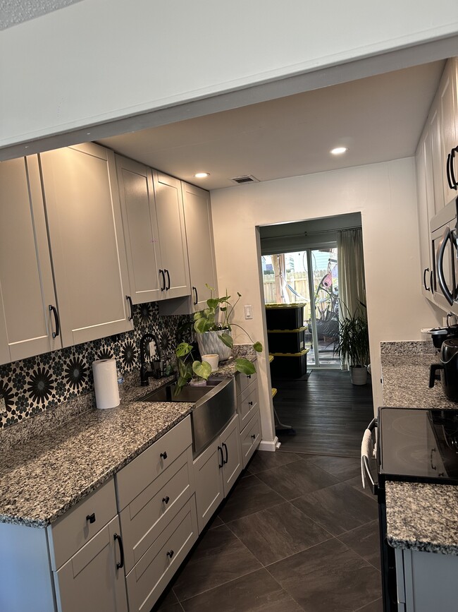 Kitchen area with update appliances and modern finishes - 3613 Harbinger Rd