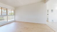 Located at 4143 Palmwood Dr in Los Angeles, CA, this compact yet well-designed single-floor, one-bedroom, one-bathroom unit makes efficient use of its space across six distinct rooms. The interior is characterized by a clean, bright aesthetic throughout, with crisp white walls and an abundance of natural light.

The living room and bedroom feature light wood laminate flooring and distinctive white beamed ceilings that add architectural character and a sense of height. Large windows in multiple rooms frame outdoor greenery and invite ample sunlight throughout the day. The bedroom includes a mirrored sliding closet and direct access to the hallway leading to the bathroom.

The kitchen is well-equipped with white cabinetry, light-toned countertops, a stainless steel gas range, and a full-size refrigerator. Light ceramic tile flooring runs through the kitchen, dining area, and hallway, providing a practical and cohesive transition between spaces. The dining area features large windows with views to the outside and a wall sconce for added lighting.

The bathroom is finished in white with a full-size bathtub and tiled surround, complemented by a window for natural ventilation. A connecting hallway with a wall sconce and built-in vents links all areas seamlessly, completing this functional and airy Los Angeles residence.