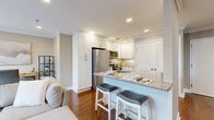 This thoughtfully designed one-bedroom, one-bathroom residence in Bergenfield, NJ offers a cohesive blend of modern finishes and functional living. Rich hardwood flooring flows throughout, complemented by crown molding and recessed lighting that create a polished, inviting atmosphere.

The open-concept kitchen is a standout feature, showcasing white shaker cabinetry, granite countertops, and a full suite of stainless steel appliances including a French door refrigerator, electric range, and over-the-range microwave. A peninsula with seating for two integrates seamlessly into the living area, ideal for casual dining or entertaining.

The living room is bright and welcoming, with multiple windows allowing natural light to fill the space. A flex area adjacent to the living room offers versatility as a home office or dining nook.

The spacious primary bedroom features two windows with neighborhood views, warm hardwood floors, and crown molding, providing a calm and comfortable retreat. The bathroom is finished with large-format tile flooring, a dark wood vanity, and a full tub-shower combination. Louvered utility closet doors add a classic touch to the overall design.