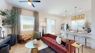 Located in Surprise, AZ, this thoughtfully designed single-story home offers one bedroom, two bathrooms, a dedicated office, and an efficient, well-appointed layout. Light-toned hardwood-style flooring flows throughout, complementing the bright white walls and creating a clean, cohesive aesthetic.

The open-concept living area is anchored by a ceiling fan and large windows that invite abundant natural light. A sliding glass door provides direct outdoor access, while the adjoining kitchen features two-toned cabinetry — white uppers paired with soft blue-gray lowers — white quartz countertops, stainless steel appliances, and a peninsula with seating. The space blends functionality with contemporary style seamlessly.

The primary bedroom is a calm retreat with plush carpeting, a large window with decorative drapery, and direct access to a private en-suite bathroom. The bathroom offers gray shaker-style cabinetry, white quartz countertops, and an undermount sink with modern fixtures.

The dedicated office is well-lit by multiple windows with views of the Arizona landscape, offering a productive and comfortable workspace. A dedicated laundry room houses a full-size washer and dryer with additional cabinetry for storage. A walk-in closet completes the home's practical and well-organized interior.